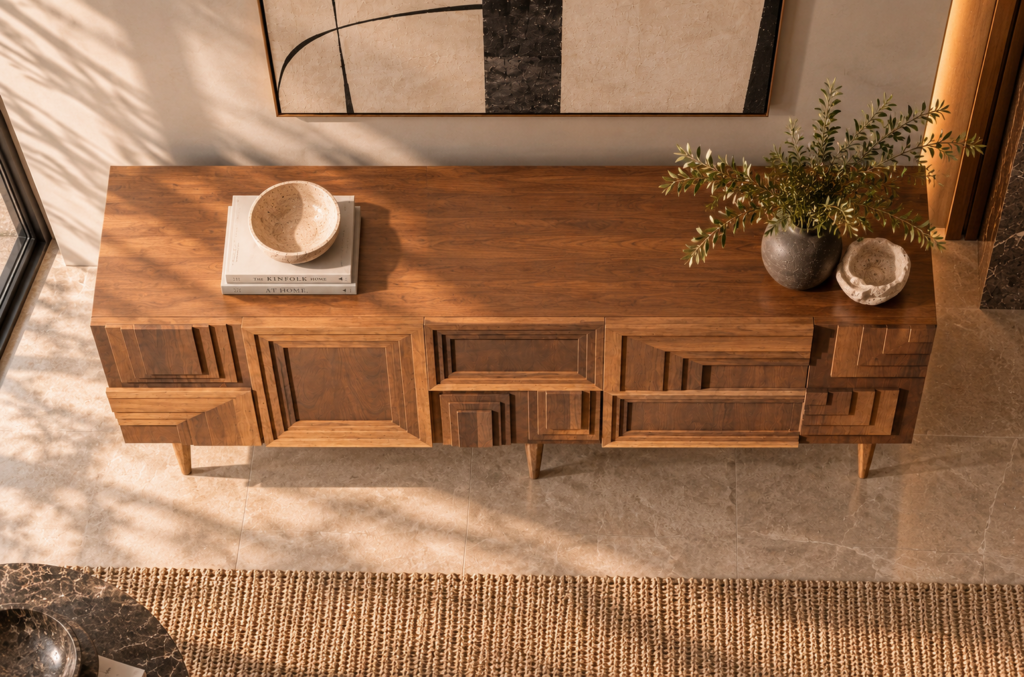 Elevated view of the Labyrinth bar cabinet in a warm brown wood finish, showing a broad top with visible grain, stepped rectangular patterns across the front and tapered legs.