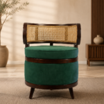 Front view of the BASSELINE chair with a dark-finished acacia wood frame, curved natural cane backrest and deep green upholstered seat.