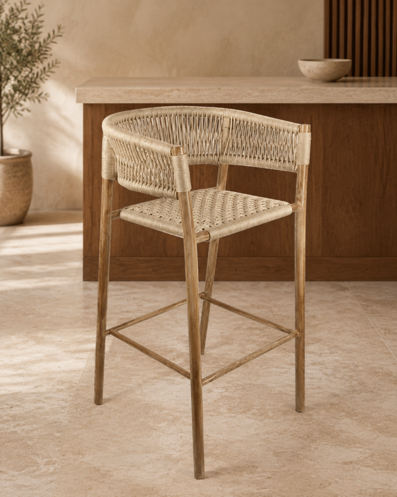 Angled front view of the BAR GARDENIA bar chair with a natural acacia wood frame, woven rope seat, curved back and integrated footrest.