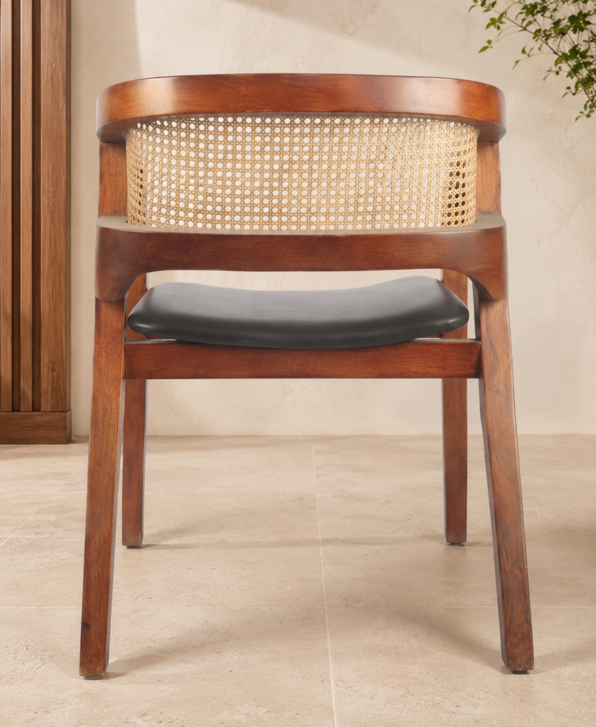 Rear view of the CAFFEINA chair with a warm-finished acacia wood frame, natural cane backrest and black upholstered seat.
