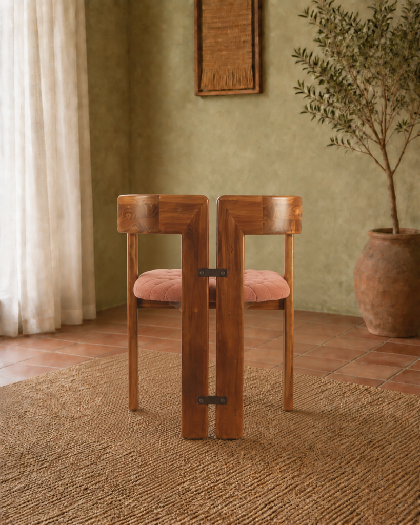 Rear view of the TRIMESTER chair, showing its solid acacia wood construction, twin geometric back sections and muted terracotta upholstered seat.