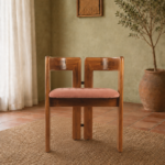 Front view of the TRIMESTER chair with a solid acacia wood frame, geometric open back and muted terracotta upholstered seat.