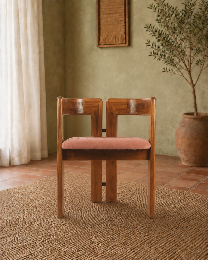 Front view of the TRIMESTER chair with a solid acacia wood frame, geometric open back and muted terracotta upholstered seat.