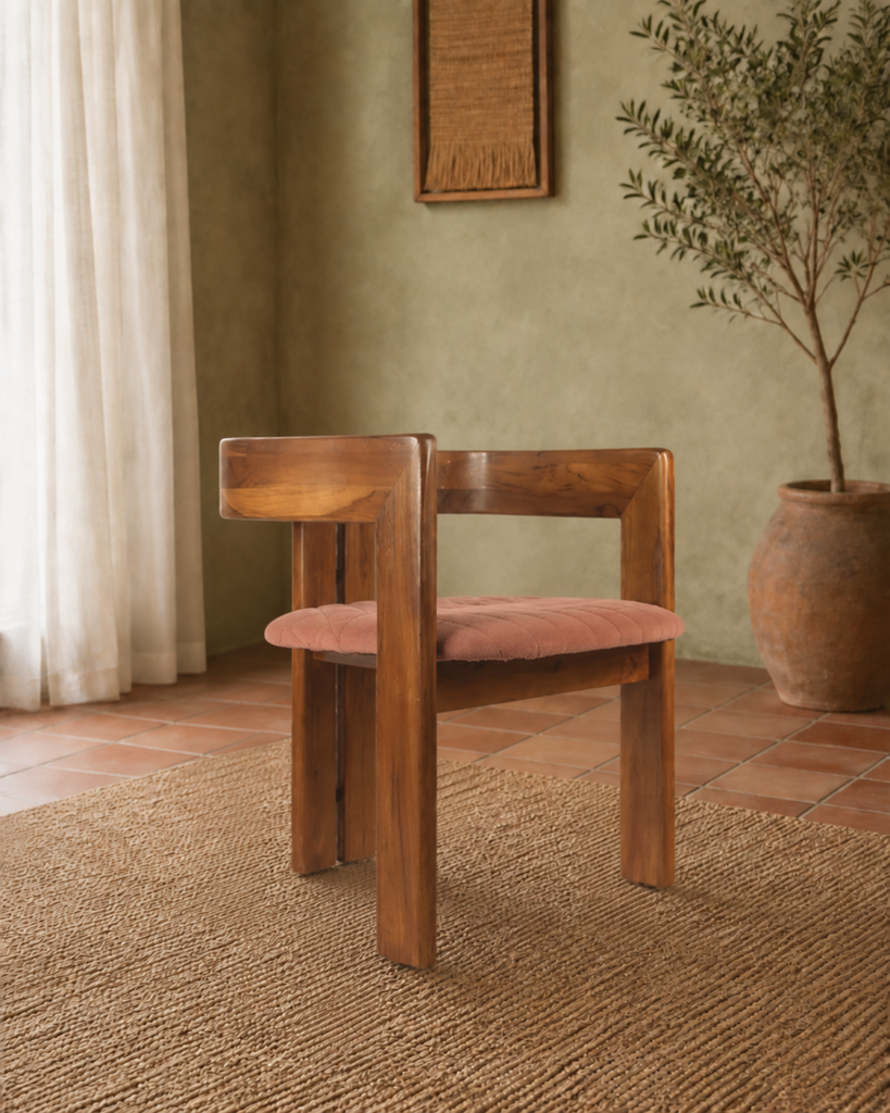 Angled front view of the TRIMESTER chair with a solid acacia wood frame, squared wraparound back and muted terracotta upholstered seat.