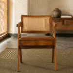 Front view of the OAKINAVA chair with a solid acacia wood frame, natural cane backrest, short arms and brown art leather seat.