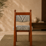 Rear view of the ZEBRONA acacia wood chair with black-and-ivory patterned upholstery.