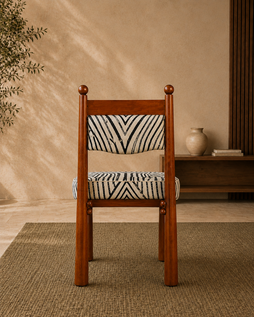 Rear view of the ZEBRONA acacia wood chair with black-and-ivory patterned upholstery.