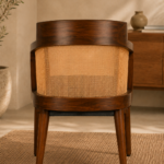 Rear view of the Caneya chair showing its dark-finished wood frame, wraparound natural cane backrest and tapered legs.