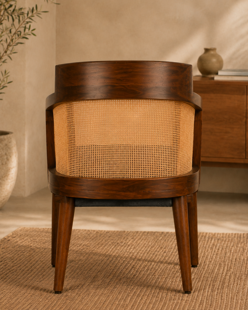 Rear view of the Caneya chair showing its dark-finished wood frame, wraparound natural cane backrest and tapered legs.