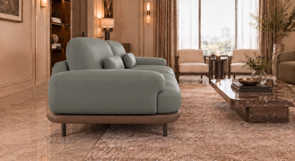 Side view of the Continentale sofa in grey-green Phantom 124 leatherette, showing a broad padded arm, angled back cushions, a teak finish base and slim dark legs.