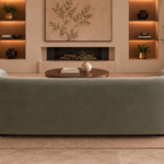 Rear view of the Formosa sofa in muted sage-green Giza 116 upholstery, showing its broad upholstered back, rounded sides and low dark feet.
