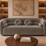 Front view of the Formosa sofa upholstered in Giza 109 fabric, featuring a continuous curved back, broad seating and coordinated round and bolster cushions.