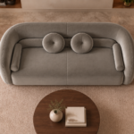 Top view of the Formosa sofa upholstered in Giza 109 fabric, featuring a continuous curved back, broad bench seating and matching bolster cushions.
