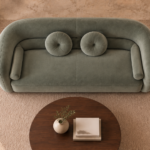 Top view of the Formosa sofa in sage-green Giza 116 upholstery, with a wraparound back, broad seat, two round cushions and side bolsters.
