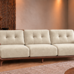Front view of the Grand Turismo Dark Wood three-seater sofa in cream Aston 904 patterned fabric, with stitched back cushions, broad wooden armrests, curved side panels and tapered legs.