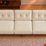 Overhead view of the Grand Turismo Dark Wood sofa in cream Aston 904 patterned fabric, showing three equal seat cushions, rectangular stitching on the back cushions and broad dark wooden armrests.