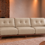 Front view of the Grand Turismo Dark Wood three-seater sofa with light beige leatherette cushions, rectangular backrest stitching, broad wooden armrests, curved side panels and tapered legs.