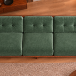 Overhead view of the Grand Turismo Dark Wood sofa in forest green Aston 921 patterned fabric, showing three equal seat cushions, rectangular backrest stitching, broad wooden armrests and a rounded frame.