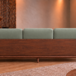 Rear view of the Grand Turismo Dark Wood sofa with three grey-green Phantom 118 leatherette back cushions, a broad wooden rear panel, rounded armrests, curved side supports and tapered legs.