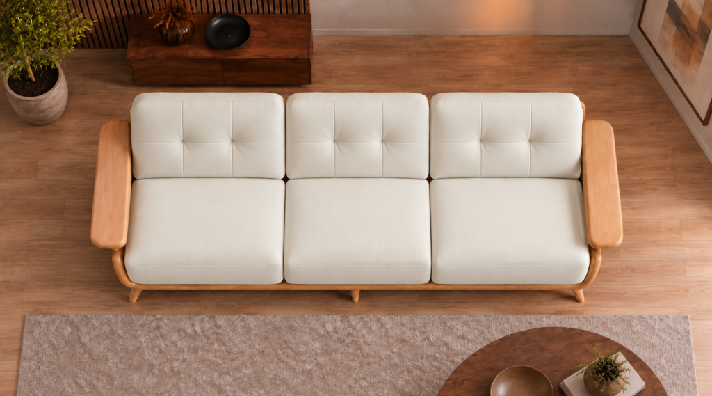 Overhead view of the Grand Turismo three-seater sofa in ivory Phantom 102 leatherette, showing three equal seat cushions, rectangular stitching on the back cushions, broad wooden armrests and a rounded frame.