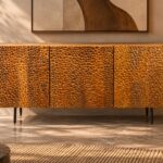 Front view of the Lunar Spec bar cabinet in a warm brown wood finish, with three deeply textured doors, a smooth rectangular top and slim dark tapered legs.