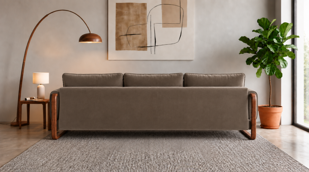 Rear view of the Madeira sofa in taupe patterned Amy 908 upholstery, featuring a continuous back panel, three separate back cushions and rounded side frames in a warm teak finish.