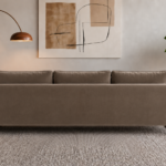 Rear view of the Madeira sofa in taupe patterned Amy 908 upholstery, featuring a continuous back panel, three separate back cushions and rounded side frames in a warm teak finish.