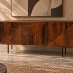 Front view of the Rhythm bar cabinet in a warm brown wood finish, featuring three doors with horizontal and vertical grooves meeting diagonally, a narrow outer frame and dark legs.