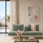 Front view of the Solaris sofa in sage green fabric, featuring a continuous bench seat, two back cushions, a central wedge bolster and an ivory platform with a mounted round side table.