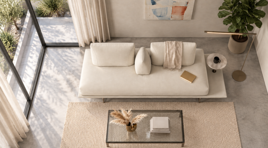 Overhead view of the Solaris sofa in ivory fabric, showing a continuous bench seat, two separate back cushions, a central wedge bolster and a round table mounted on the extended platform.