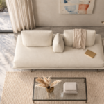 Overhead view of the Solaris sofa in ivory fabric, showing a continuous bench seat, two separate back cushions, a central wedge bolster and a round table mounted on the extended platform.
