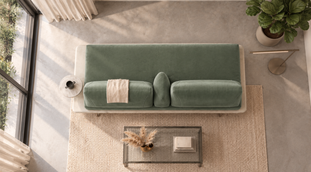Overhead view of the Solaris sofa in sage green patterned fabric, showing a continuous bench seat, two back cushions, a central wedge bolster, an ivory platform and a round side table.