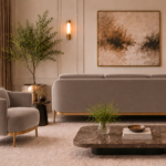 Rear view of the Duet sofa in taupe patterned Aston 925 upholstery, showing a broad rounded back, three cushion tops, gold finish base trim and slender legs, alongside a matching armchair.