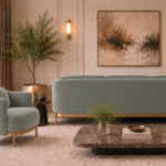 Rear view of the Duet sofa in grey-green Phantom 118 leatherette, showing a broad upholstered back, rounded corners and gold finish base trim, with a matching armchair alongside.