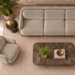 Top view of the Duet three-seater sofa and matching armchair in light beige patterned Aston 924 upholstery, showing aligned seat and back cushions, curved arms and gold finish base trim.